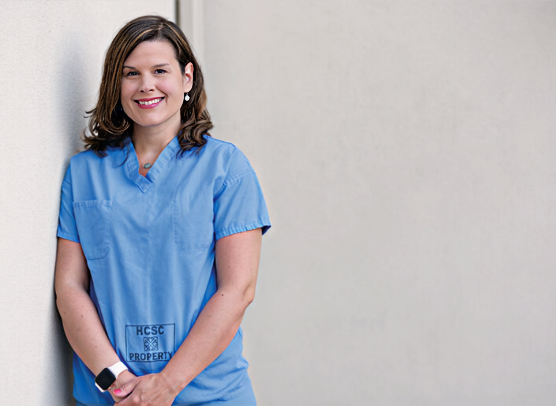 Stefanie Mensch Ott, Certified Registered Nurse Anesthetist, in medical scrubs in a clinical setting.