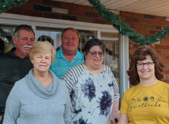 Raymond Kreiger poses with family members in a casual outdoor group photo during a holiday gathering.